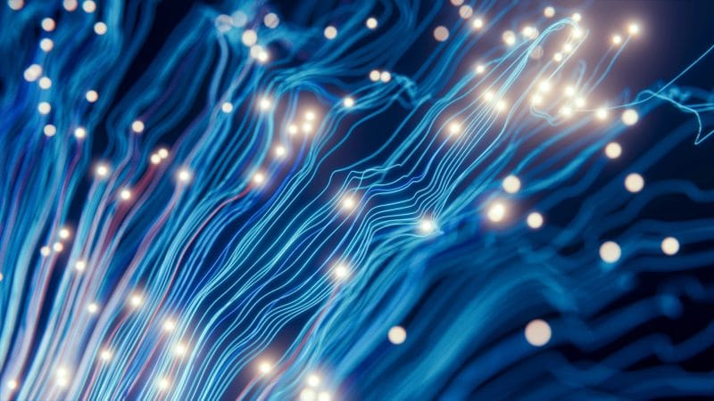 Abstract blue light trails with glowing نقاط on a dark background